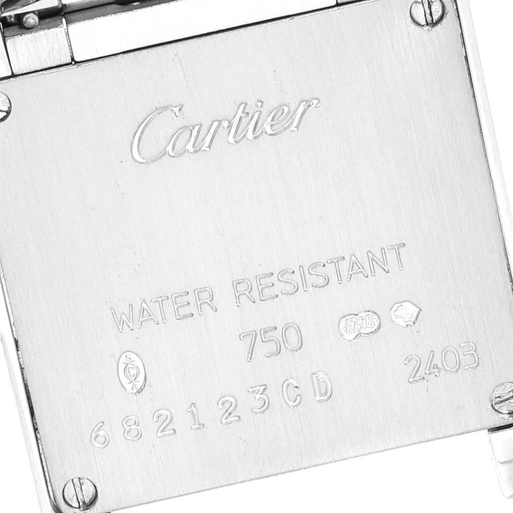 This image shows the back case of a Cartier Tank Francaise WE1002SF Women
s White Gold Silver Dial WE1002SF Women
s White Gold Silver Dial watch, featuring engravings and hallmarks.