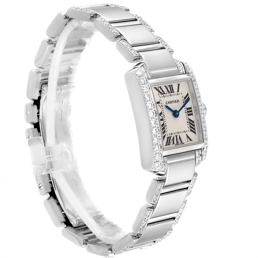 This image shows a Cartier Tank Francaise WE1002SF Women
s White Gold Silver Dial WE1002SF Women
s White Gold Silver Dial watch from a diagonal angle, featuring its bracelet, case, dial, and blue hands.