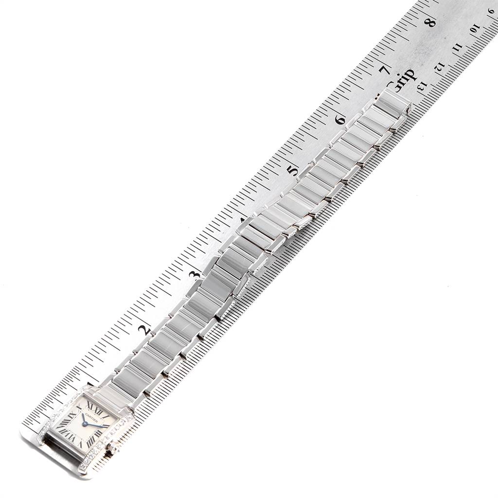 The Cartier Tank Francaise WE1002S3 Women's White Gold Silver Dial WE1002S3 Women's White Gold Silver Dial watch is shown from a top view, highlighting the face, bracelet, and a ruler for scale.