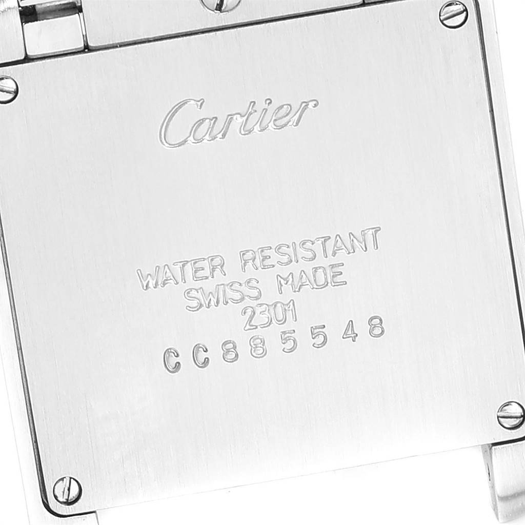 The image shows the back of a Cartier Tank Française watch, displaying brand engraving and serial number.