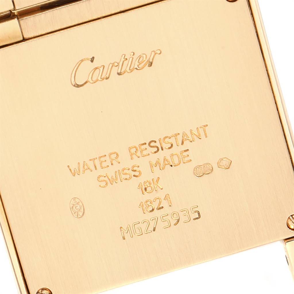 The image shows the back of a Cartier Tank Française watch, featuring text indicating its specifications and serial number.