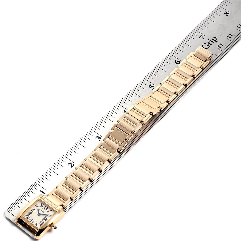 The image shows a Cartier Tank Francaise W50002N2 Women's Yellow Gold Silver Dial W50002N2 Women's Yellow Gold Silver Dial watch laid flat next to a ruler, showcasing the watch face and full bracelet.