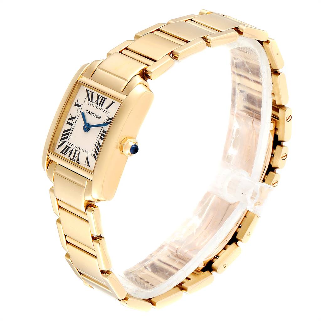 The image shows a Cartier Tank Francaise W50002N2 Women's Yellow Gold Silver Dial W50002N2 Women's Yellow Gold Silver Dial watch in a three-quarter angle, highlighting its gold bracelet, rectangular face, and blue cabochon crown.