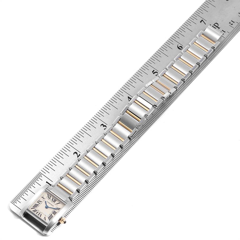The image shows the Cartier Tank Francaise W51007Q4 Women's Steel and Gold (two tone) Silver Dial W51007Q4 Women's Steel and Gold (two tone) Silver Dial watch laid alongside a ruler, focusing on its band and rectangular face.