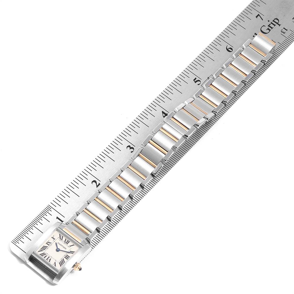 The image shows a close-up of the Cartier Tank Francaise W51007Q4 Women's Steel and Gold (two tone) Silver Dial W51007Q4 Women's Steel and Gold (two tone) Silver Dial watch laid out next to a ruler, displaying its strap and face.
