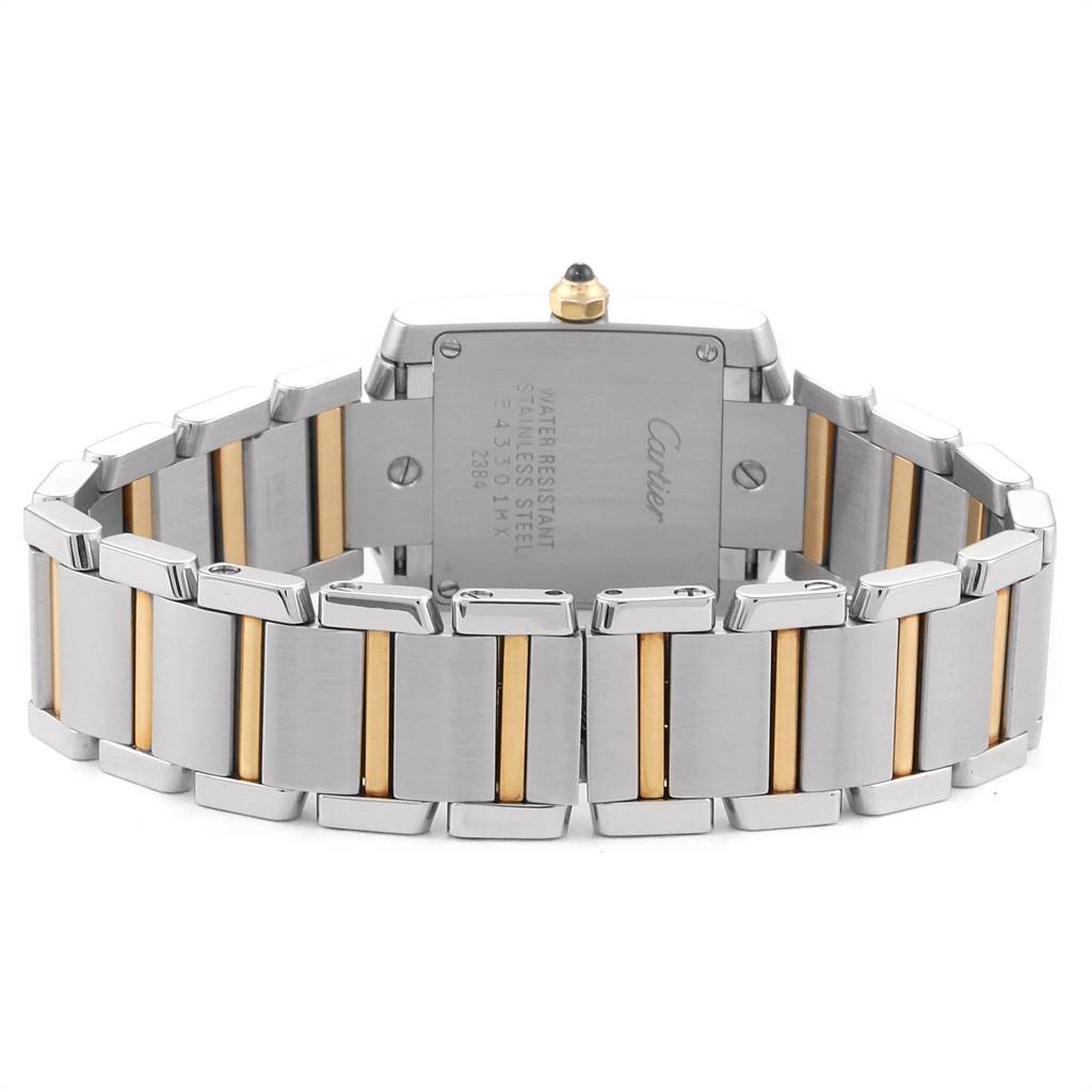 The image shows the back view of a Cartier Tank Française watch, highlighting the stainless steel and gold bracelet.