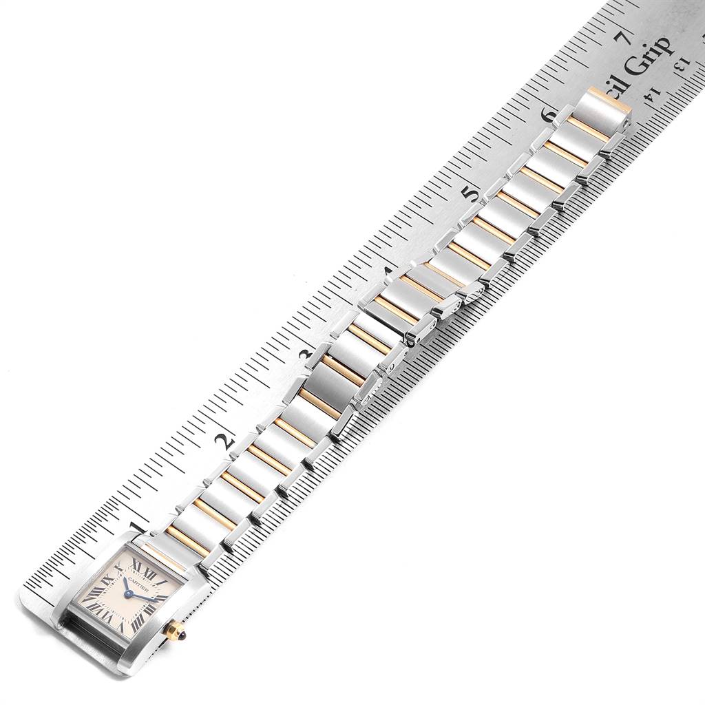This image shows a top view of a Cartier Tank Francaise W51007Q4 Women's Steel and Gold (two tone) Silver Dial W51007Q4 Women's Steel and Gold (two tone) Silver Dial watch aligned with a ruler, displaying the face and bracelet.