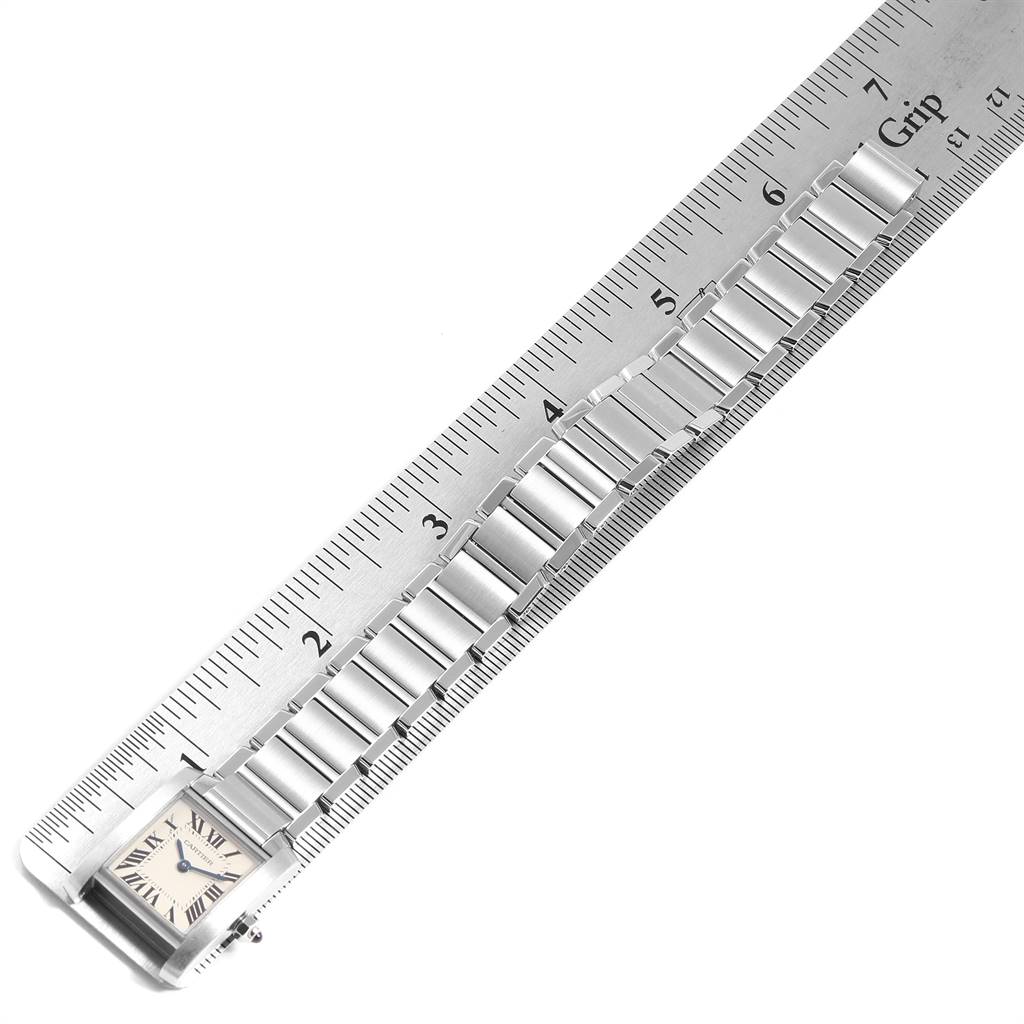 The Cartier Tank Francaise W51008Q3 Women's Stainless Steel Silver Dial W51008Q3 Women's Stainless Steel Silver Dial watch is shown from a top-down angle, displaying the face and the full length of the metal bracelet against a ruler.