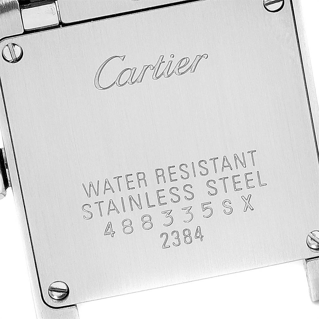 This image shows the engraved case back of a Cartier Tank Française watch, highlighting its water resistance and stainless steel composition.