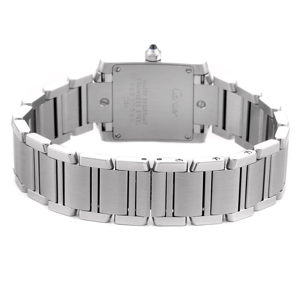 The image shows the back view of a Cartier Tank Française watch, highlighting the stainless steel bracelet and case back.