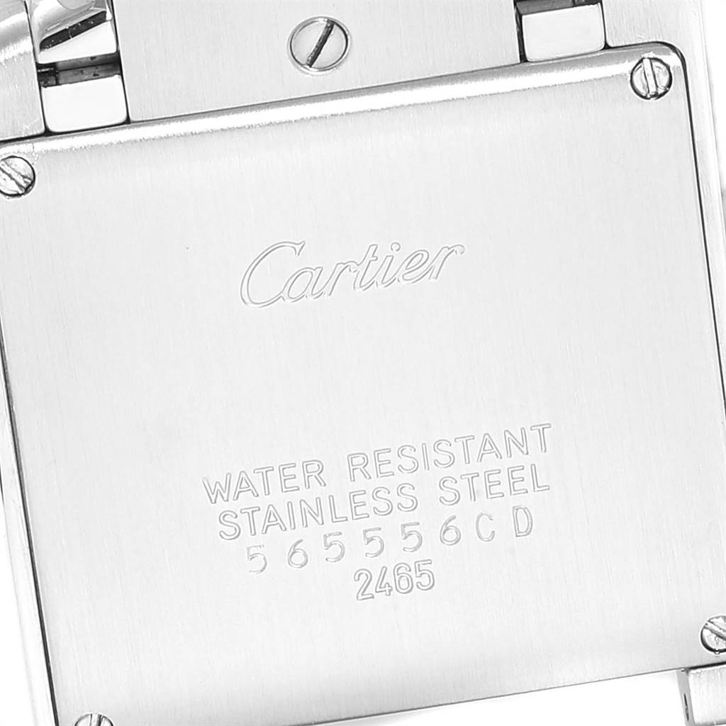 The image shows a close-up of the back case of a Cartier Tank Française watch, highlighting its stainless steel and water-resistant markings.
