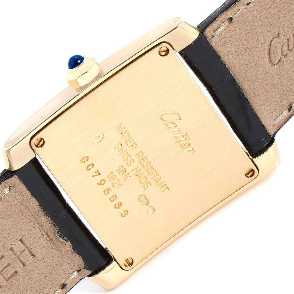 The image shows the back of a Cartier Tank Française watch, featuring its case, leather strap, and inscriptions.