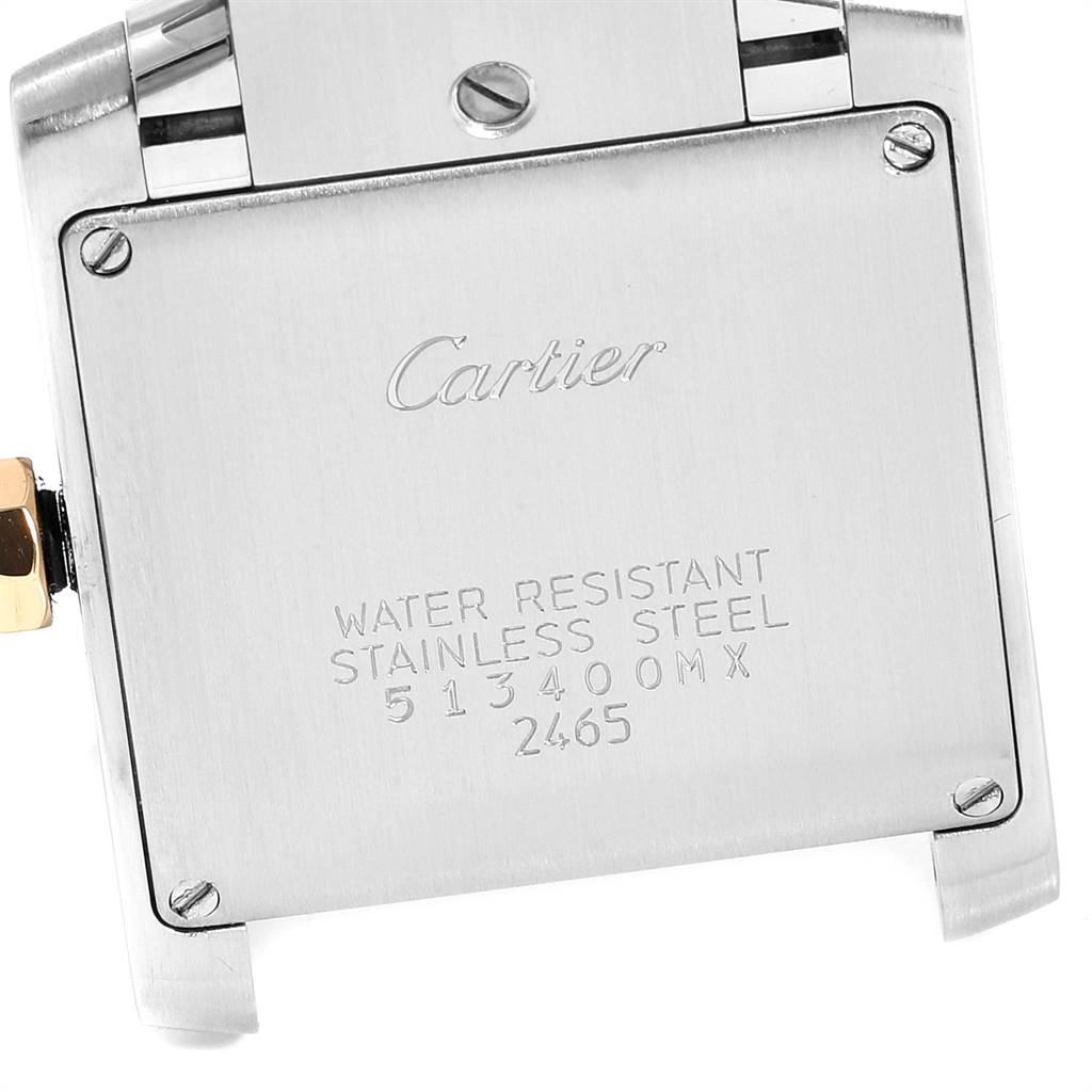 The image shows a close-up of the back case of a Cartier Tank Francaise W51012Q4 Women's Steel and Gold (two tone) Silver Dial W51012Q4 Women's Steel and Gold (two tone) Silver Dial watch, highlighting the engraved details and screws.