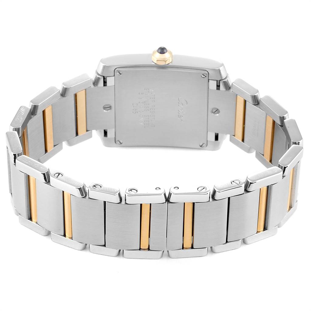 The image shows the back view of a Cartier Tank Française watch, highlighting the stainless steel and gold bracelet.