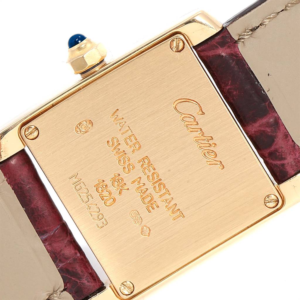This image shows the backplate and straps of the Cartier Tank Francaise W50002N2 Women's Yellow Gold Silver Dial W50002N2 Women's Yellow Gold Silver Dial watch, emphasizing its markings and materials.