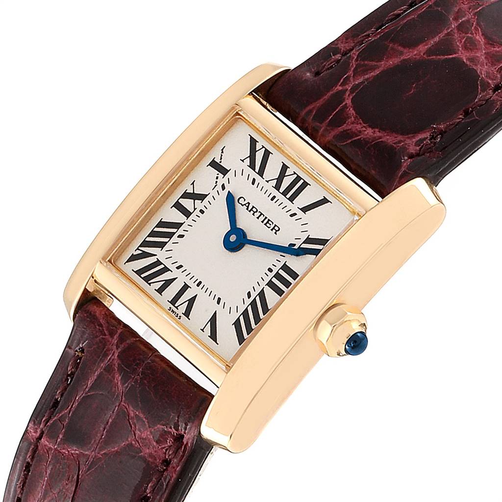 This image shows a Cartier Tank Francaise W50002N2 Women's Yellow Gold Silver Dial W50002N2 Women's Yellow Gold Silver Dial watch at an angle displaying the face, crown, and part of the strap.