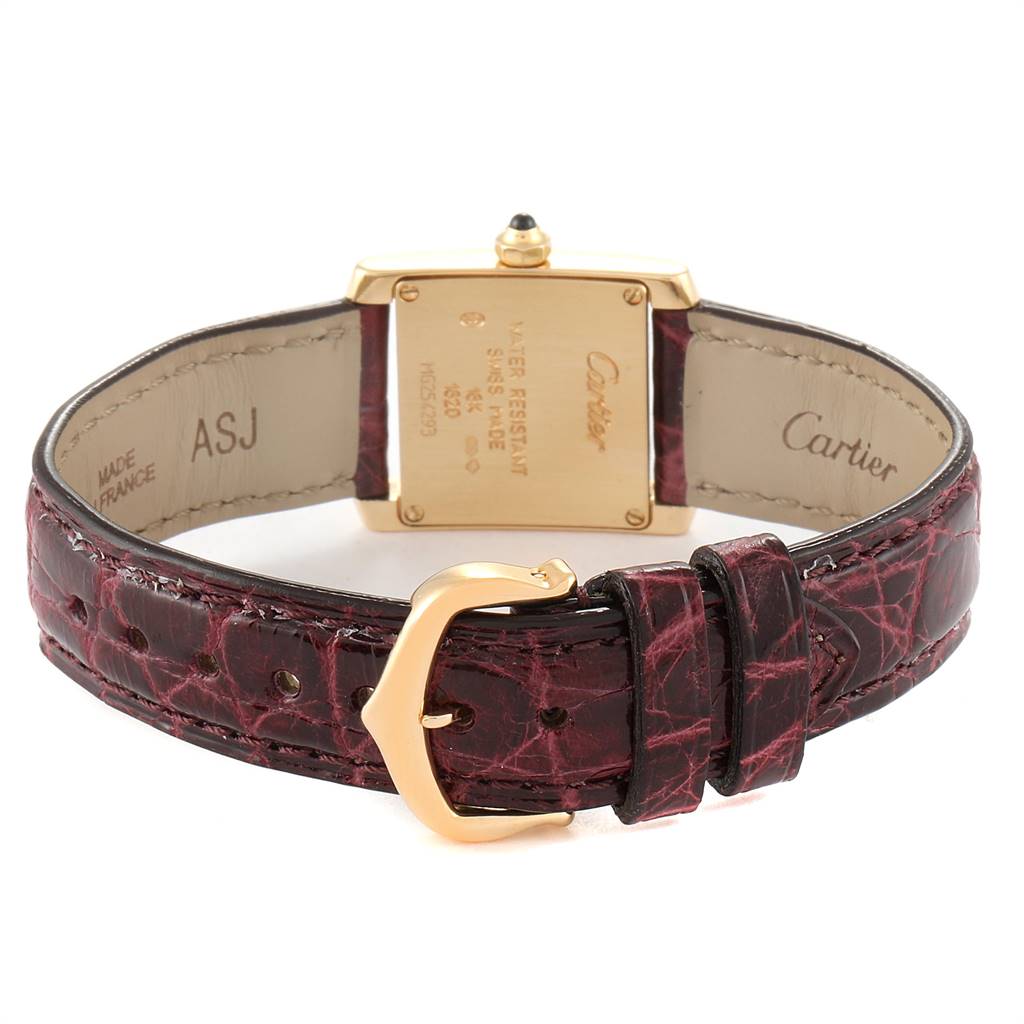 The image displays the back of the Cartier Tank Française watch, showcasing its caseback and leather strap with buckle.