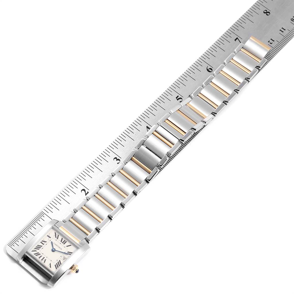 The Cartier Tank Francaise W51012Q4 Women's Steel and Gold (two tone) Silver Dial W51012Q4 Women's Steel and Gold (two tone) Silver Dial watch is shown at an angle, highlighting the face, band, and ruler for size reference.