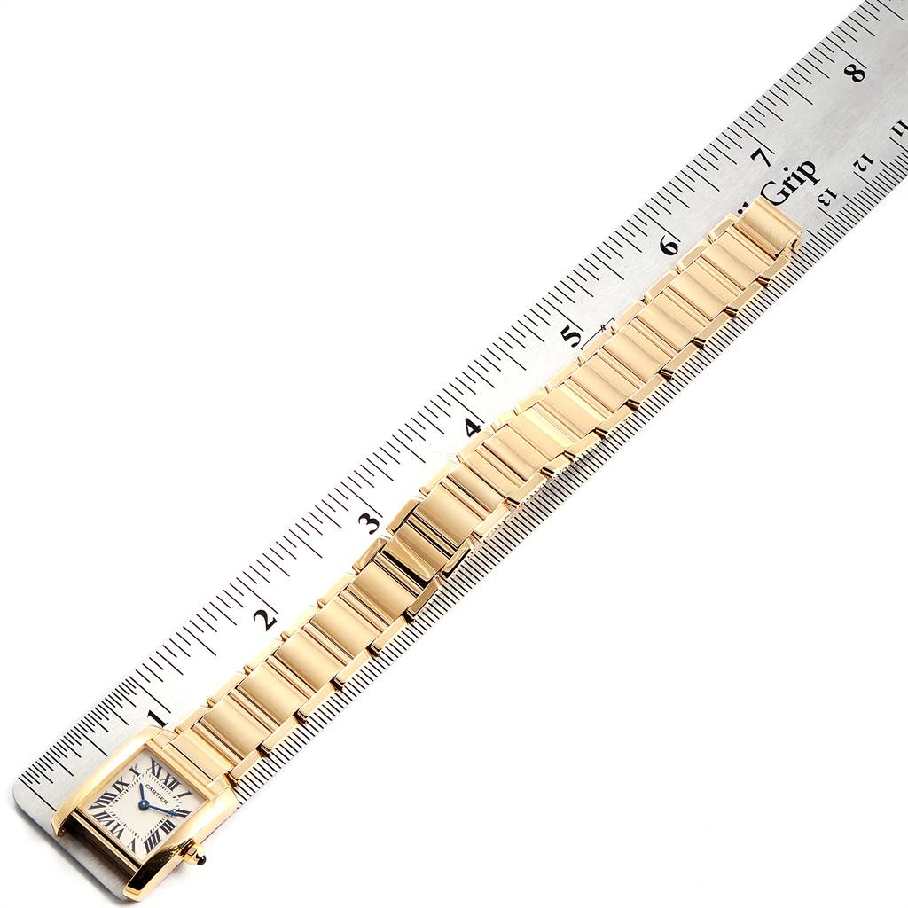 The image shows a side angle of the Cartier Tank Francaise W50002N2 Women's Yellow Gold Silver Dial W50002N2 Women's Yellow Gold Silver Dial watch, highlighting its gold bracelet and rectangular face.