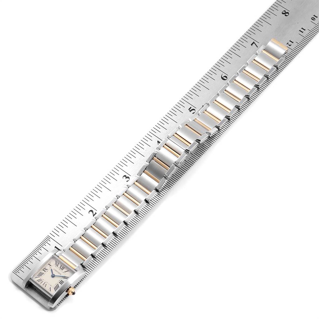 The image shows the Cartier Tank Francaise W51007Q4 Women's Steel and Gold (two tone) Silver Dial W51007Q4 Women's Steel and Gold (two tone) Silver Dial watch's face and part of the band next to a ruler for measurement.