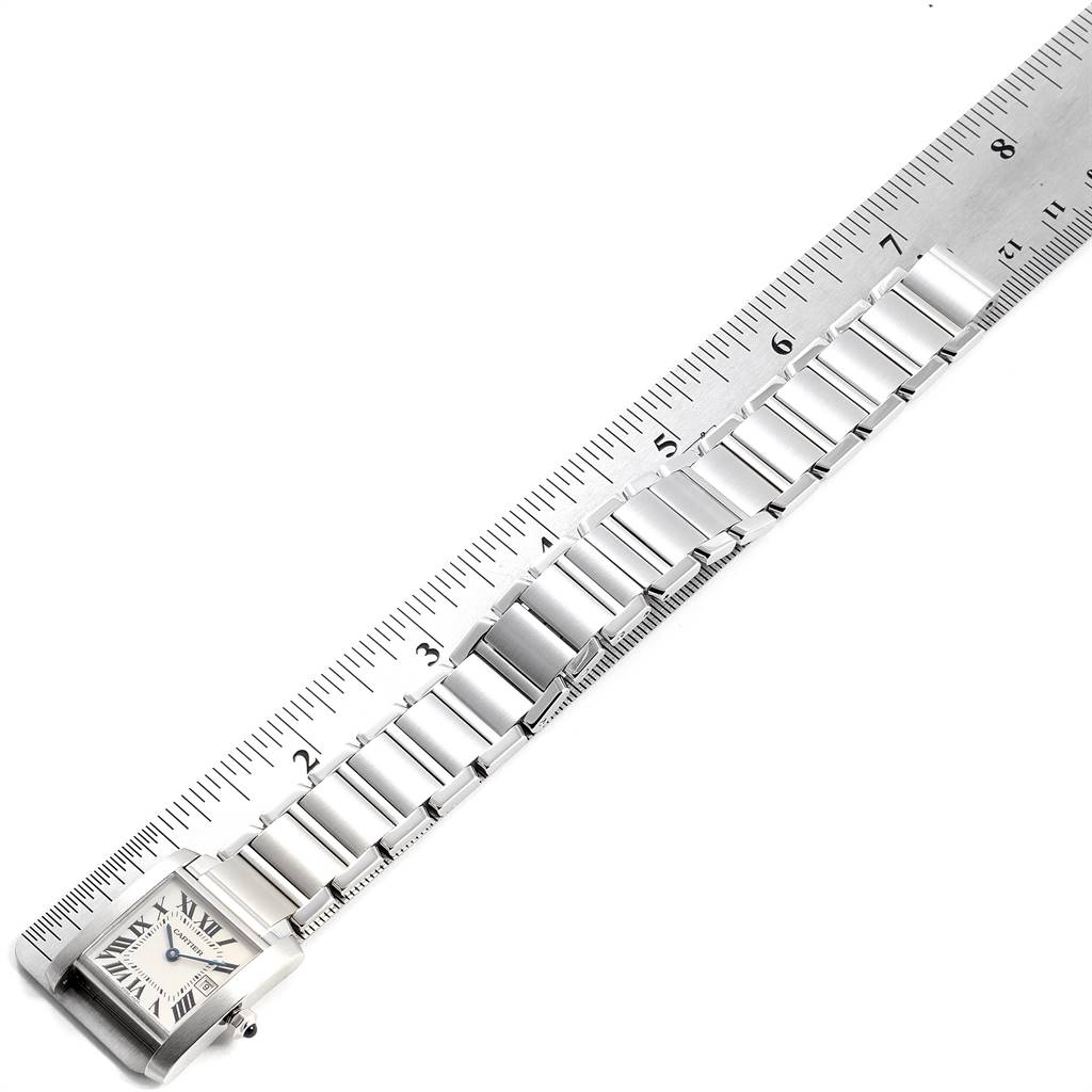The image shows the face and bracelet of a Cartier Tank Francaise W51011Q3 Women
s Stainless Steel Silver Dial W51011Q3 Women
s Stainless Steel Silver Dial watch alongside a ruler for measurement.