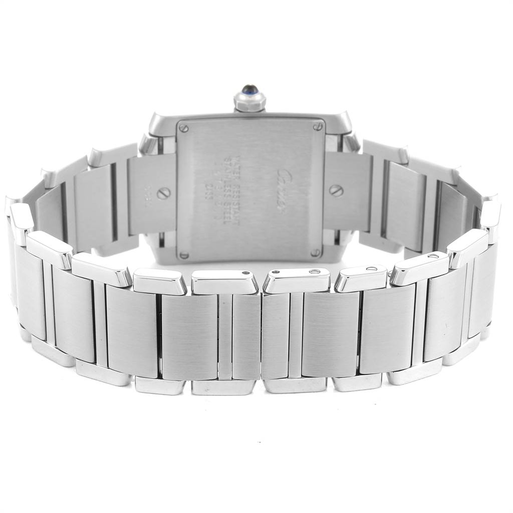 The image shows the back view of a Cartier Tank Française watch, highlighting its stainless steel bracelet and case back.
