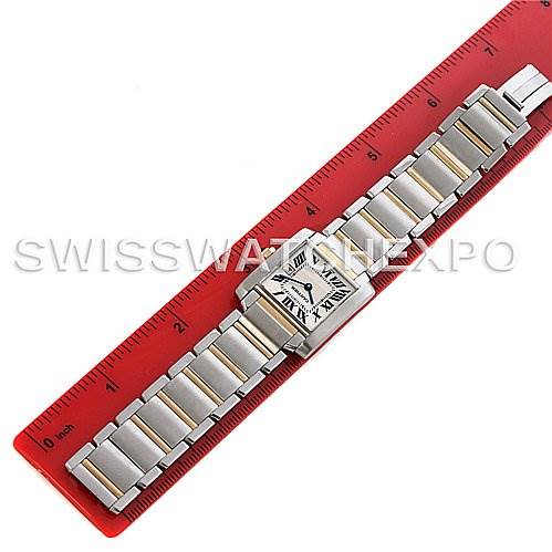 This image shows a Cartier Tank Française watch, laid flat on a red ruler, displaying its face and entire bracelet.