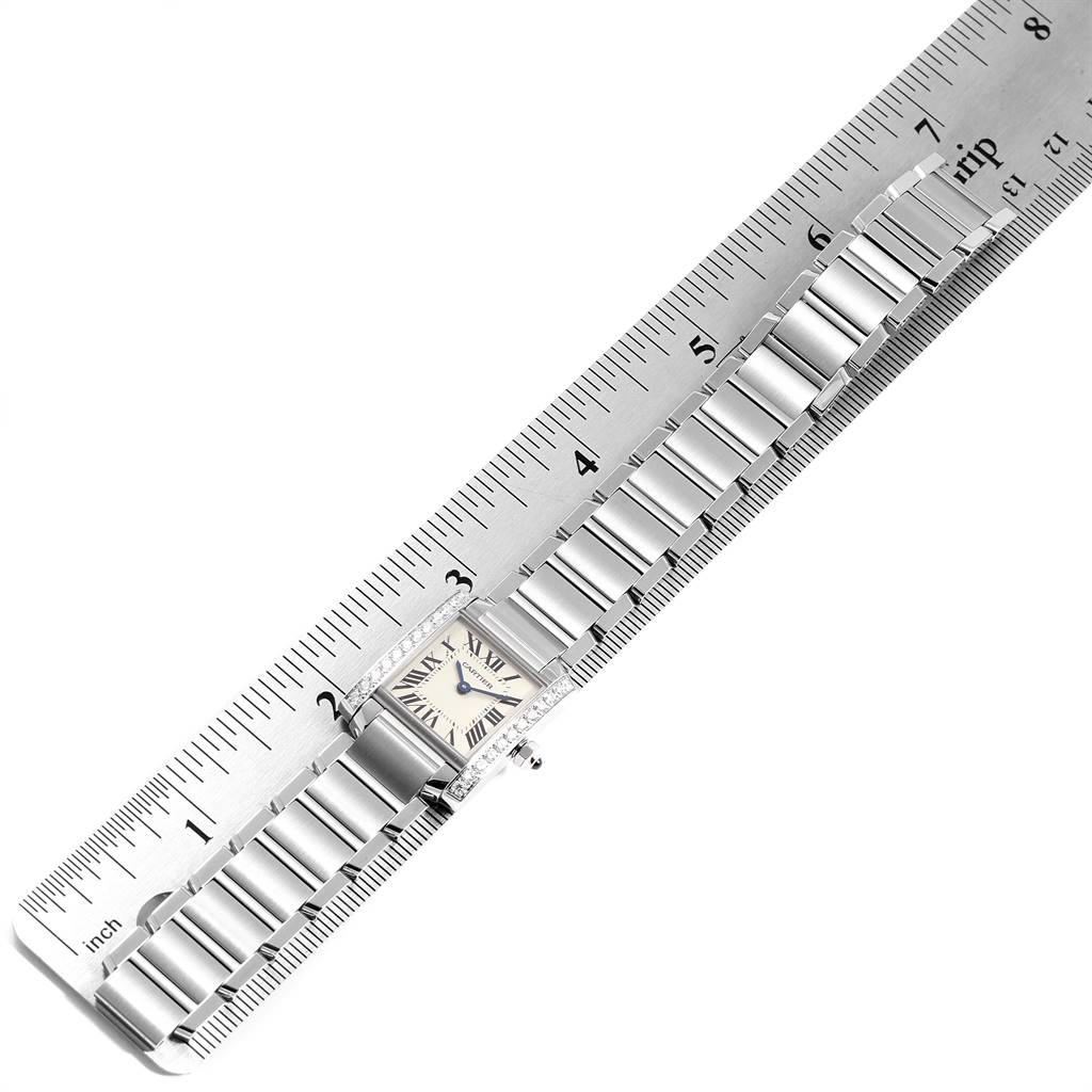 The image shows a Tank Francaise watch by Cartier, displaying its face and full metal bracelet alongside a ruler for scale.