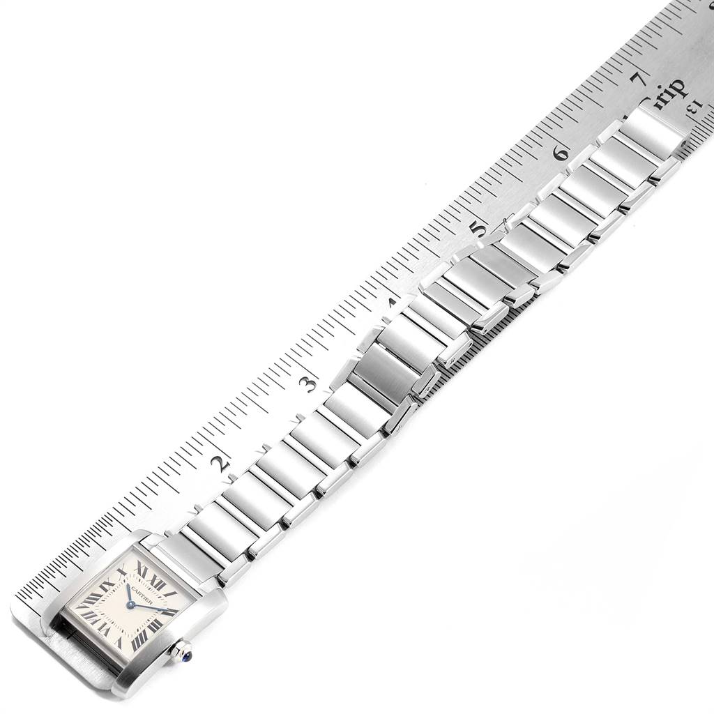 The image shows a Tank Française watch by Cartier, displayed flat and measured against a ruler.