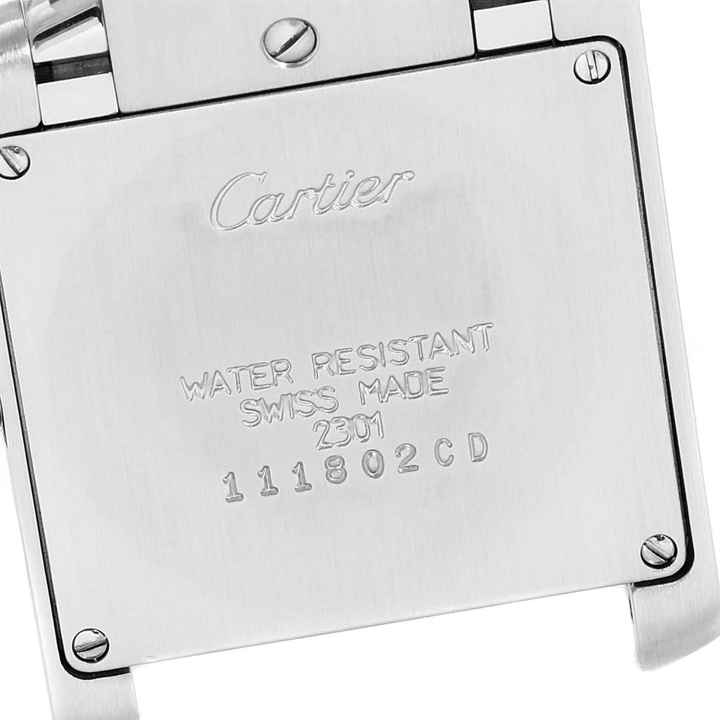 This image shows the back case of a Cartier Tank Francaise WSTA0005 Women
s Stainless Steel Silver Dial WSTA0005 Women
s Stainless Steel Silver Dial watch, highlighting its engravings and screws.