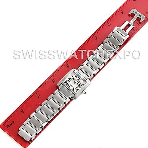 The image shows a Cartier Tank Française watch laid flat next to a red ruler, displaying the watch face and entire metal bracelet.