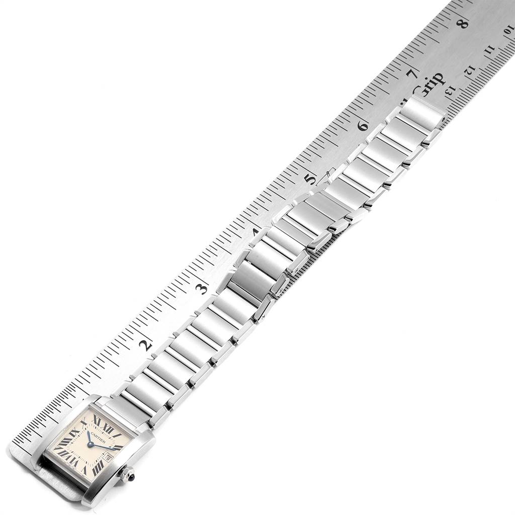 The image shows the Tank Francaise watch by Cartier, highlighting the face and entire bracelet, aligned with a ruler for measurement.