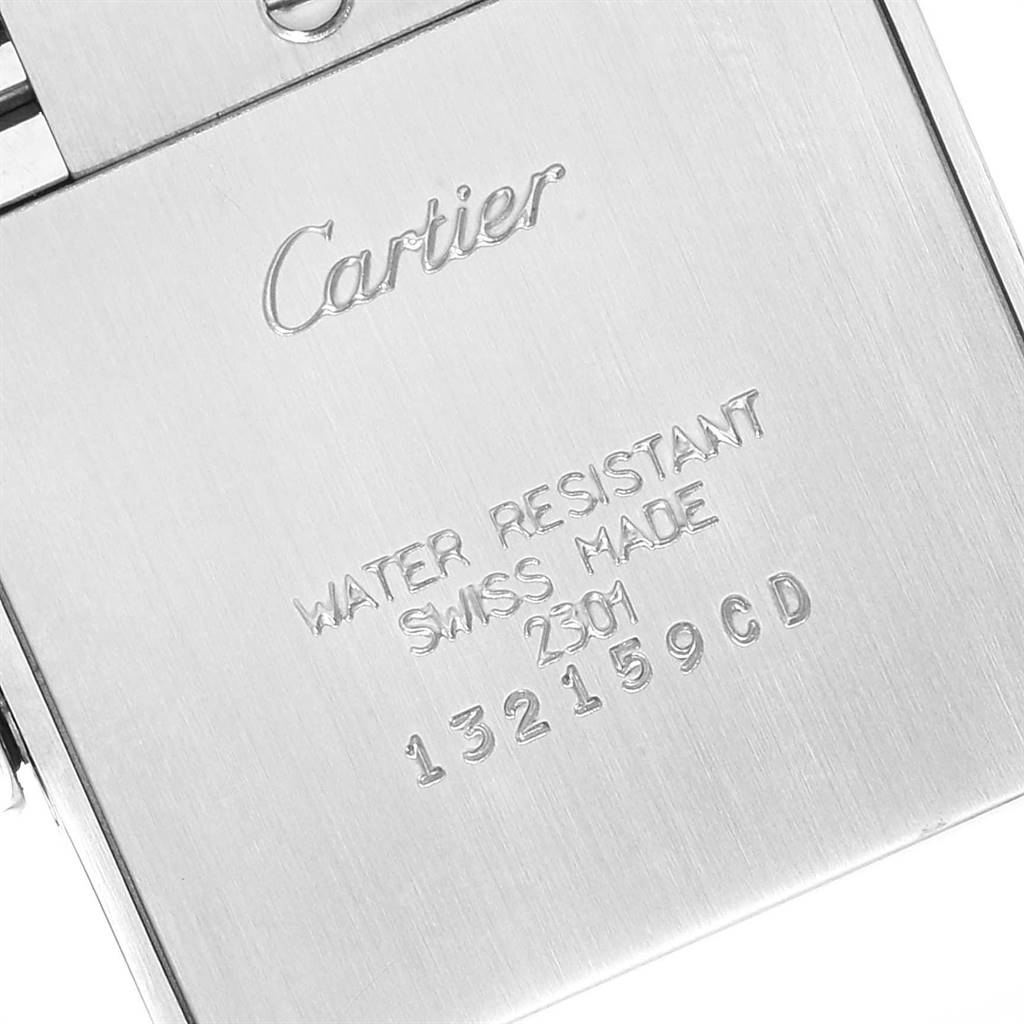 The image shows the back case of a Cartier Tank Francaise WSTA0005 Women
s Stainless Steel Silver Dial WSTA0005 Women
s Stainless Steel Silver Dial watch, displaying engravings detailing water resistance and serial numbers.