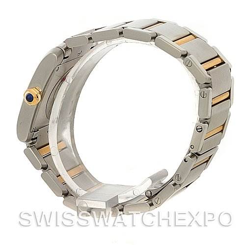 The image shows a side angle of a Cartier Tank Française watch, focusing on the metal bracelet and crown with a blue cabochon.