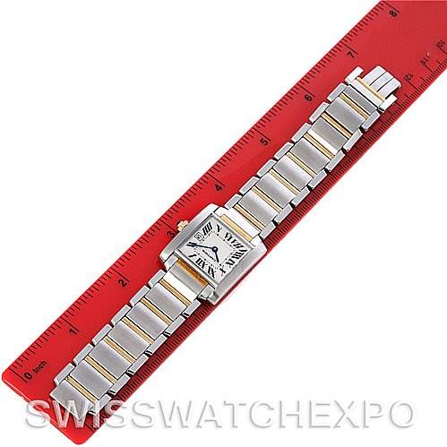 The Cartier Tank Francaise W51012Q4 Women's Steel and Gold (two tone) Silver Dial W51012Q4 Women's Steel and Gold (two tone) Silver Dial watch is laid flat next to a red ruler, displaying its face and metal bracelet.