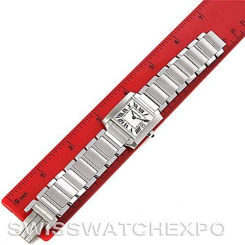 The image shows a Cartier Tank Francaise W51011Q3 Women's Stainless Steel Silver Dial W51011Q3 Women's Stainless Steel Silver Dial watch lying flat against a red ruler, displaying its face and full metal bracelet.