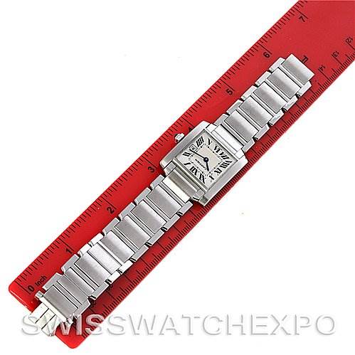 The Cartier Tank Francaise W51011Q3 Women's Stainless Steel Silver Dial W51011Q3 Women's Stainless Steel Silver Dial watch is shown from an overhead angle, placed against a red ruler for scale.