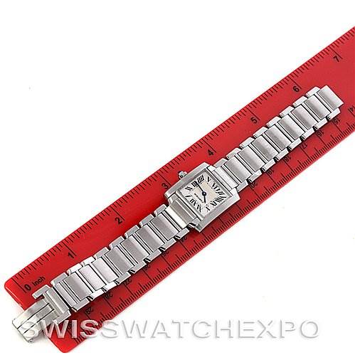 The image shows a Cartier Tank Francaise W51008Q3 Women's Stainless Steel Silver Dial W51008Q3 Women's Stainless Steel Silver Dial watch laid flat next to a red ruler displaying its length.