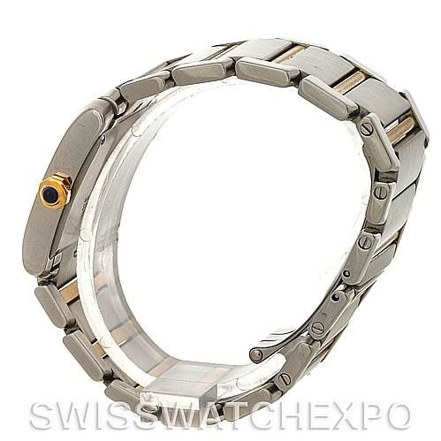 The image shows a side view of the bracelet and case of a Cartier Tank Française watch, highlighting the metal links and the crown with a blue cabochon.