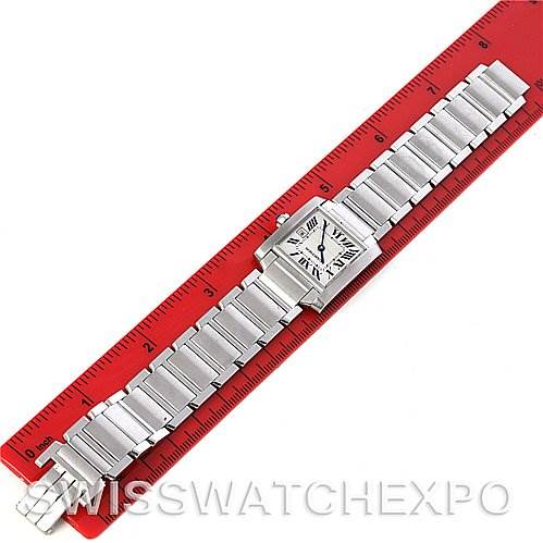 The image shows a top-down view of a Cartier Tank Francaise W51011Q3 Women's Stainless Steel Silver Dial W51011Q3 Women's Stainless Steel Silver Dial watch with a metal band placed on a red ruler for scale.