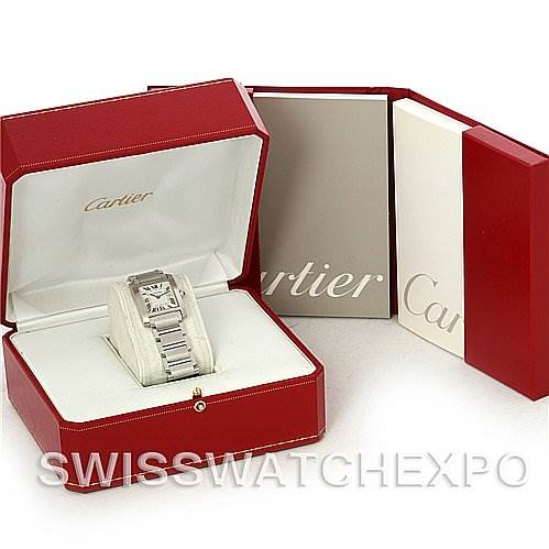 The image shows a Cartier Tank Française watch in its red case, with additional boxes and booklets in the background.