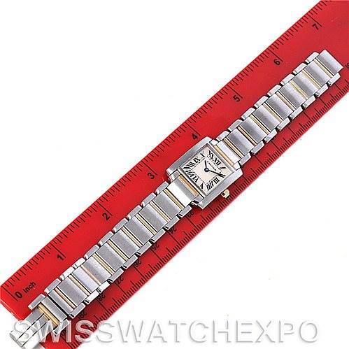 This image shows a top-down view of a watch with a metal bracelet placed alongside a red ruler; the model is a Yacht-Master by Rolex.