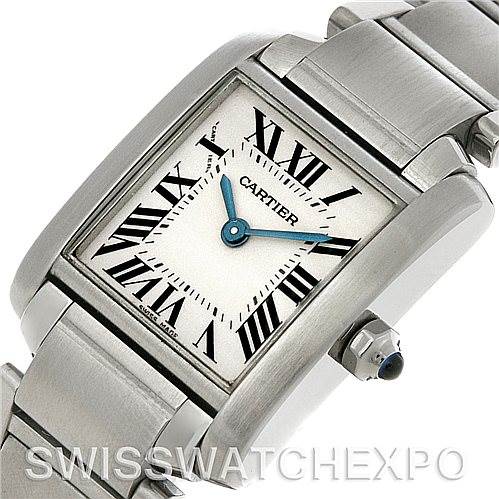 The image shows a close-up of the Cartier Tank Française watch at an oblique angle, highlighting its face, Roman numerals, crown, and stainless steel bracelet.