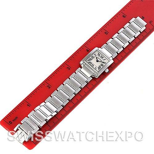 The image shows a Cartier Tank Francaise W51008Q3 Women
s Stainless Steel Silver Dial W51008Q3 Women
s Stainless Steel Silver Dial watch lying flat against a red ruler, displaying the watch face and entire metal bracelet.