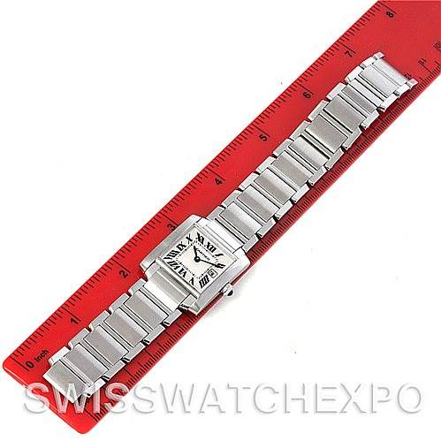 This image shows a full view of the Cartier Tank Française watch laid flat against a red ruler, highlighting its bracelet and square dial.