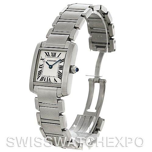 The image shows a side angle of a Cartier Tank Française watch, highlighting its bracelet, rectangular face with Roman numerals, and blue gemstone crown.