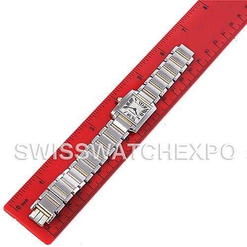 The Cartier Tank Francaise W51007Q4 Steel and Gold (two tone) Silver Dial W51007Q4 Steel and Gold (two tone) Silver Dial watch is shown from a top-down angle, fully extended alongside a red ruler for scale.