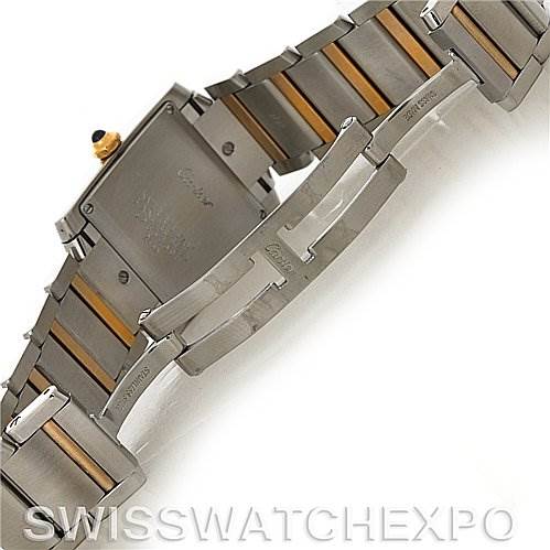 The image shows the underside and clasp mechanism of the Cartier Tank Française watch, highlighting its stainless steel and gold bracelet.