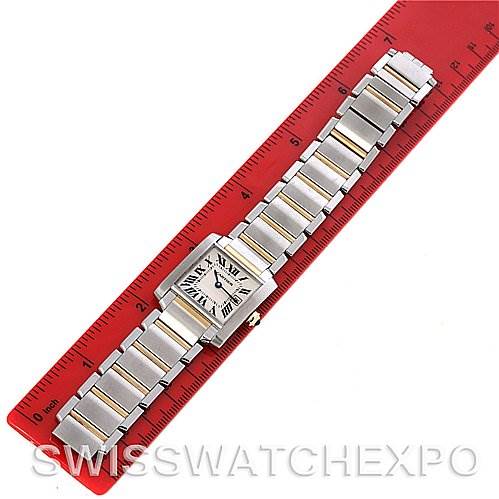 The image shows a Cartier Tank Francaise W51012Q4 Women's Steel and Gold (two tone) Silver Dial W51012Q4 Women's Steel and Gold (two tone) Silver Dial watch laid flat next to a red ruler, displaying the entire bracelet and face.