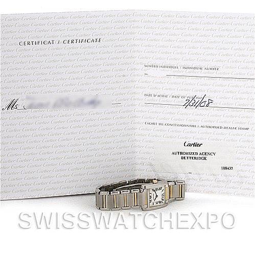 The image shows a Cartier Tank Française watch laid flat with its certificate and documentation in the background.